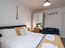 A bedroom with a bed and a wardrobe at The Four Views in Whitby