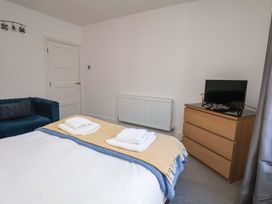 A bedroom with a bed and television at The Four Views in Whitby
