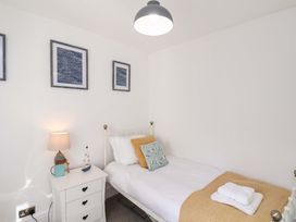 A bedroom with a single bed and a nightstand at The Four Views in Whitby