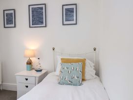 A bedroom with a bed and nightstand at The Four Views in Whitby