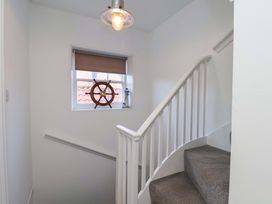 A staircase with a window and light fixture at The Four Views in Whitby