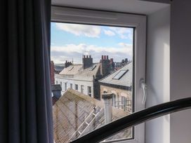 A view from a window showing rooftops and chimneys at The Four Views in Whitby