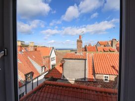 A view of rooftops and the ocean at The Four Views in Whitby