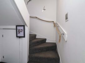 A staircase with a handrail and a sign at The Four Views in Whitby