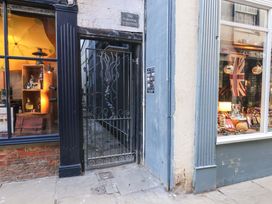 An outdoor view of a storefront entrance and gate at The Hideaway in Whitby