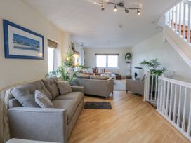 A living room with sofas and a coffee table at Snowdonia View in Pwllheli