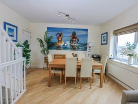 A dining room with a table and chairs at Snowdonia View in Pwllheli