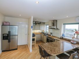 A kitchen with refrigerator and countertop at Snowdonia View in Pwllheli