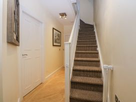 A hallway with a staircase and a door at Snowdonia View in Pwllheli