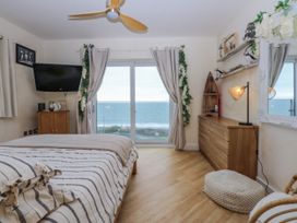 A bedroom with a view of the sea at Snowdonia View in Pwllheli
