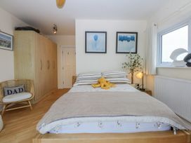 A bedroom with a bed and wardrobe at Snowdonia View in Pwllheli