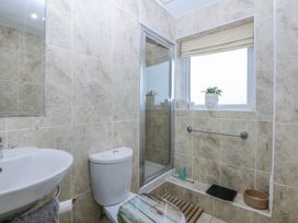 A bathroom with a sink, toilet, and shower at Snowdonia View in Pwllheli