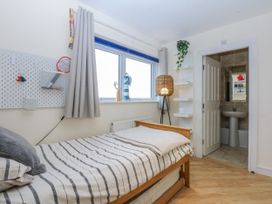 A bedroom with a bed and an ensuite bathroom at Snowdonia View in Pwllheli