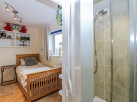 A bedroom with a bed and shower at Snowdonia View Pwllheli