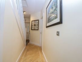 A hallway with a staircase and wall art at Snowdonia View in Pwllheli