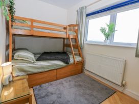 A bedroom with a bunk bed and a window at Snowdonia View in Pwllheli