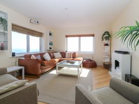 A living room with a sofa and coffee table at Snowdonia View in Pwllheli