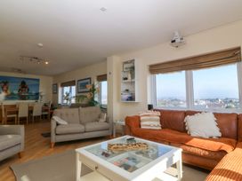 A living room with a sofa and dining table at Snowdonia View in Pwllheli