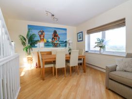 A dining room with a table and chairs at Snowdonia View in Pwllheli