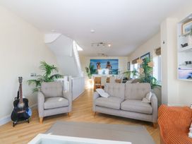 A living room with sofas and a dining area at Snowdonia View in Pwllheli