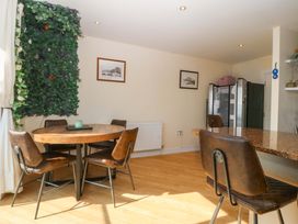 A dining room with a table and chairs at Snowdonia View in Pwllheli