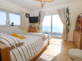 A bedroom with a bed and television at Snowdonia View in Pwllheli
