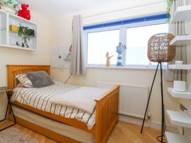 A bedroom with a bed and window at Snowdonia View in Pwllheli