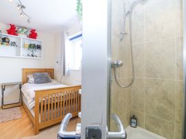 A bedroom with a bed and a shower at Snowdonia View in Pwllheli