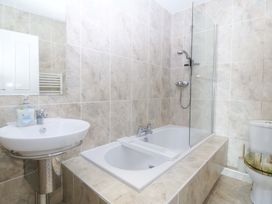 A bathroom with a bathtub and shower at Snowdonia View in Pwllheli