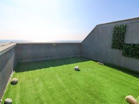 An outdoor space with artificial grass and rocks at Snowdonia View in Pwllheli