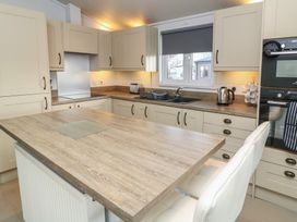 A kitchen with cabinets and island at Fairways 22 in Lincoln
