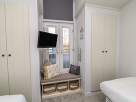 A bedroom with a television and window at Fairways 22 in Lincoln