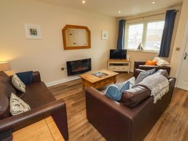 A living room with sofas and a television at 35 Longbeach Drive
