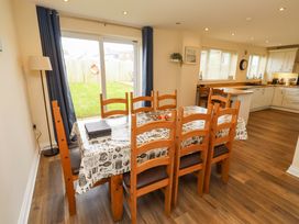 A dining room with a table and chairs at 35 Longbeach Drive