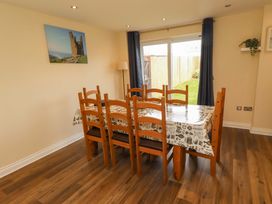 A dining room with a table and chairs at 35 Longbeach Drive