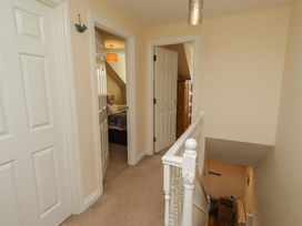 A hallway with doors and staircase at 35 Longbeach Drive