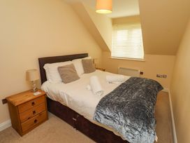 A bedroom with a bed and bedside table at 35 Longbeach Drive