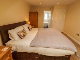 A bedroom with a bed and wardrobe at 35 Longbeach Drive