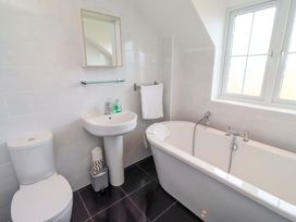 A bathroom with a sink, toilet and bathtub at 35 Longbeach Drive