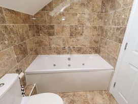 A bathroom with a bathtub and toilet at 35 Longbeach Drive