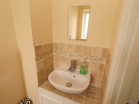 A sink with a mirror and soap dispenser in a bathroom at 35 Longbeach Drive