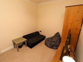 A snug with a sofa and a side table at 35 Longbeach Drive