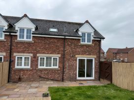 An outdoor view of a house with a garden at Nautilus in Beadnell