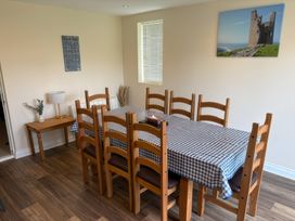 A dining room with a large table and chairs at Nautilus Beadnell