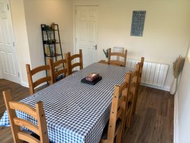 A dining room with a table and chairs at Nautilus Beadnell