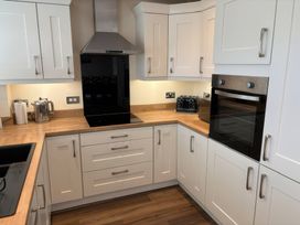 A kitchen with cabinets and appliances at Nautilus Beadnell