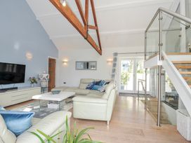 A living room with a sofa and coffee table at The Cowshed in Portscatho