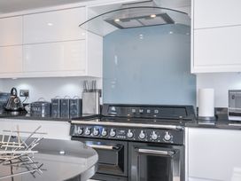 A kitchen with a SMEG oven and various containers at The Cowshed in Portscatho