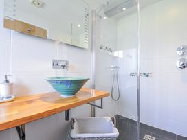 A bathroom with a shower and sink at The Cowshed in Portscatho