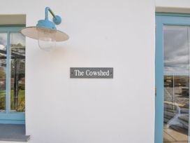 An exterior view with a sign reading The Cowshed at The Cowshed in Portscatho